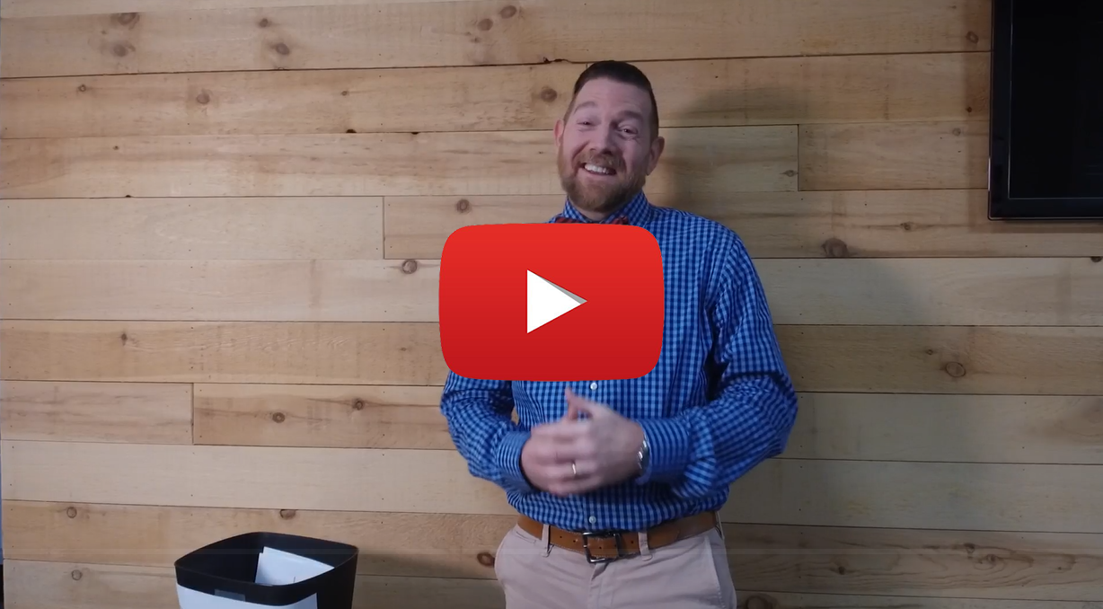 Lean TIp of the Week Overproduction Play Button A video still of Project Manager Nathan Bonds smiling with red YouTube play button.