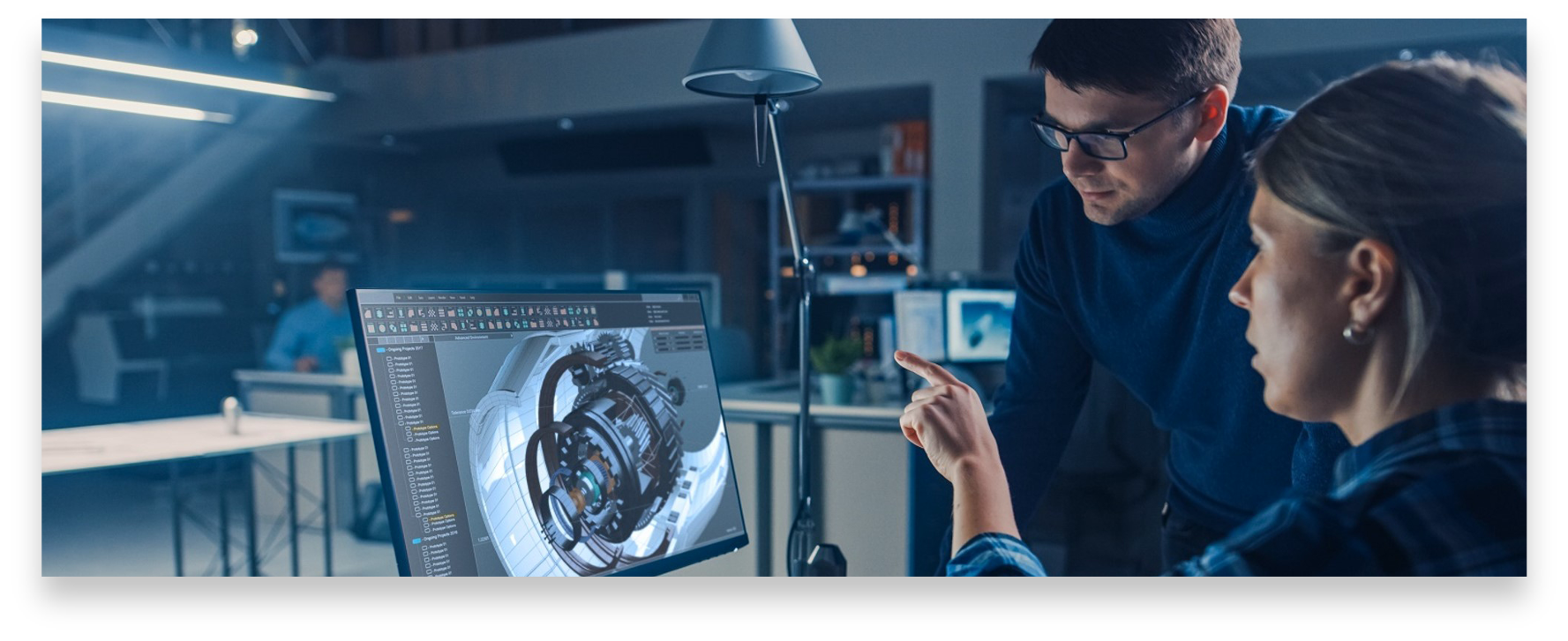 Defense Manufacturing Community Support Program Woman and man look at computer monitor with graphic of manufactured component for defense