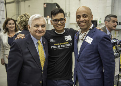 Senator Jack Reed, JARC RI trainee Raul Cusillos, and Rhode Island Manufacturers Association Board of Directors member Mark Cousineau.