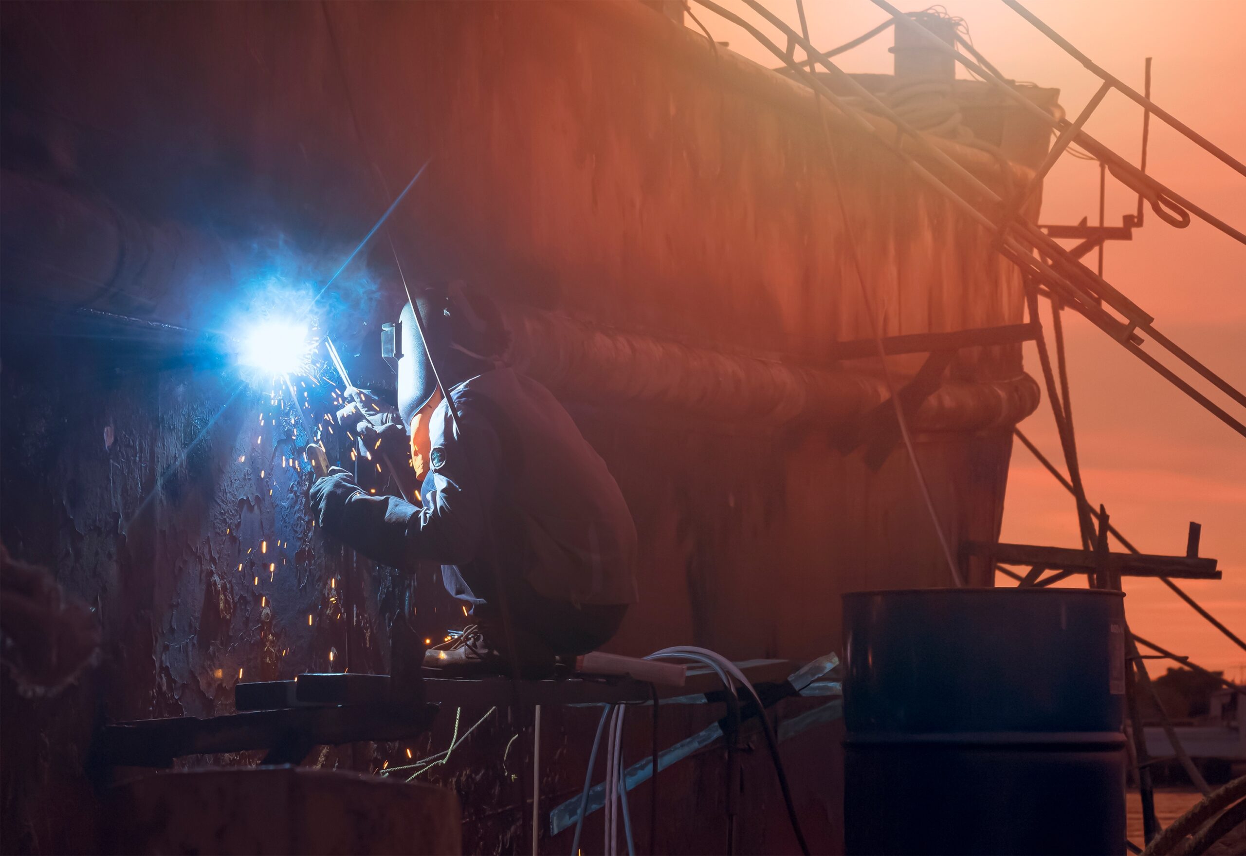 shipyard-worker-welding-metal-at-sunset-2026-09-22-03-07-25-utc